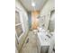 Bathroom with a standard toilet, sink, and window, but graffiti on the walls may detract some buyers at 637 Olin Ave, Indianapolis, IN 46222