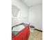 Bathroom with red vanity, grey countertop, and toilet showing signs of disrepair at 637 Olin Ave, Indianapolis, IN 46222