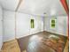 Bedroom featuring hardwood floor, unfinished wall repair, windows, and natural light at 637 Olin Ave, Indianapolis, IN 46222