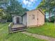 View of the home's exterior with gray siding and small porch with stairs at 637 Olin Ave, Indianapolis, IN 46222