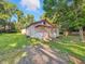 View of a home with red trim details set against a backdrop of lush greenery at 637 Olin Ave, Indianapolis, IN 46222