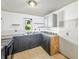 Kitchen with black cabinetry, open shelving, and a double basin sink, offering renovation possibilities at 637 Olin Ave, Indianapolis, IN 46222