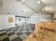 Spacious living room featuring checkerboard floors, two ceiling fans, and natural light from multiple windows at 637 Olin Ave, Indianapolis, IN 46222