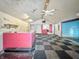 Large room with black and white checkerboard floor, ceiling fans, and graffiti-style wall decor at 637 Olin Ave, Indianapolis, IN 46222