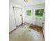 Sunroom with multiple windows, exterior door, and peeling floor tiles indicating need for repair at 637 Olin Ave, Indianapolis, IN 46222