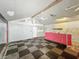 Open space with black and white checkerboard floor, ceiling fan, and graffiti-style wall decor at 637 Olin Ave, Indianapolis, IN 46222