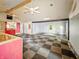 Open-concept space with black and white checkerboard floor, ceiling fans, and unfinished walls at 637 Olin Ave, Indianapolis, IN 46222