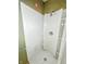 Close-up of a shower with white tile, a corner shelf and showing potential for renovation at 637 Olin Ave, Indianapolis, IN 46222