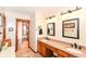 Bright bathroom with double vanity, granite countertops, and a doorway leading to a walk-in closet at 662 Leah Way, Greenwood, IN 46142