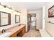 Spacious bathroom features a double vanity, tile floor, and access to the primary bedroom at 662 Leah Way, Greenwood, IN 46142