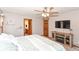 Cozy bedroom with a ceiling fan, TV, and ensuite bathroom access for added convenience at 662 Leah Way, Greenwood, IN 46142