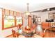 The dining area features a modern glass-topped table, wood chairs and a view of the living room at 662 Leah Way, Greenwood, IN 46142