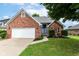 Beautiful single-story brick home with well-manicured lawn and two-car garage at 662 Leah Way, Greenwood, IN 46142