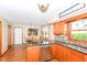 A well-lit kitchen features stainless appliances, a granite counter, a stainless sink and wood cabinets and opens to a dining area at 662 Leah Way, Greenwood, IN 46142