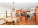 An eat-in kitchen features an island with a sink, wood cabinets, granite counters, mosaic backsplash and stainless appliances at 662 Leah Way, Greenwood, IN 46142