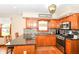 A well-lit eat-in kitchen features stainless appliances, a black granite counter, wood cabinets and mosaic backsplash at 662 Leah Way, Greenwood, IN 46142