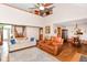 The well-lit living room features a sofa, an oversized chair, a fan and a view of the dining area at 662 Leah Way, Greenwood, IN 46142
