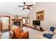 Cozy living room featuring a fireplace, ceiling fan, and comfortable seating on hardwood floors at 662 Leah Way, Greenwood, IN 46142
