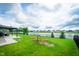 Spacious backyard with lush green grass, a lake view, and a playground at 7147 Prelude Rd, Brownsburg, IN 46112