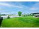 Expansive backyard with lake views, a water fountain, and lush landscaping at 7147 Prelude Rd, Brownsburg, IN 46112