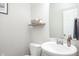 Half bathroom featuring a modern sink, toilet, mirror and shelf at 7147 Prelude Rd, Brownsburg, IN 46112