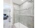 Bathroom showcasing a glass-enclosed shower with stylish gray tile and modern fixtures at 7147 Prelude Rd, Brownsburg, IN 46112