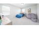 Bright bedroom featuring a vibrant bed, bean bag chair, and ample natural light at 7147 Prelude Rd, Brownsburg, IN 46112