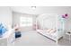 Whimsical bedroom featuring a canopy bed, a play area, and soft pastel colors at 7147 Prelude Rd, Brownsburg, IN 46112