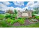 Landscaped community entrance sign with colorful flowers and lush greenery at 7147 Prelude Rd, Brownsburg, IN 46112