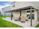 Cozy covered patio with outdoor seating and a well-manicured lawn at 7147 Prelude Rd, Brownsburg, IN 46112
