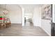 Spacious foyer with a modern light fixture and plank flooring, flows seamlessly into living spaces at 7147 Prelude Rd, Brownsburg, IN 46112