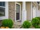 Detailed view of the front door, enhanced by stylish stonework and manicured shrubbery at 7147 Prelude Rd, Brownsburg, IN 46112