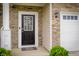 The home's front door has sidelights, stone and horizontal siding at 7147 Prelude Rd, Brownsburg, IN 46112