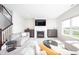 Bright living room with fireplace, TV, and view of the back yard through a big window at 7147 Prelude Rd, Brownsburg, IN 46112