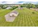 Spacious property featuring a large outbuilding, well-maintained lawn, and a cozy home in a peaceful setting at 7304 E Stop 11 Rd, Indianapolis, IN 46259
