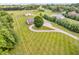 Expansive property featuring a well-manicured lawn, circular driveway, and charming home with mature trees at 7304 E Stop 11 Rd, Indianapolis, IN 46259
