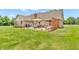 Backyard patio with an outdoor dining table, chairs, grill, privacy lattice, and outdoor seating at 7304 E Stop 11 Rd, Indianapolis, IN 46259