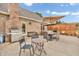 Backyard patio with dining and seating areas alongside a brick home on a sunny day at 7304 E Stop 11 Rd, Indianapolis, IN 46259