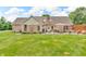 Brick home featuring an outdoor seating area, grill, and dining set in the private backyard at 7304 E Stop 11 Rd, Indianapolis, IN 46259