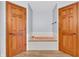 Inviting bathroom with a soaking tub and a double-door entryway for added privacy at 7304 E Stop 11 Rd, Indianapolis, IN 46259