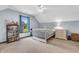 Well-lit bedroom featuring a white bed frame, ceiling fan, and large window with outside view at 7304 E Stop 11 Rd, Indianapolis, IN 46259