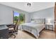 Bedroom featuring wood floors, a desk area and a picturesque view of the outdoors at 7304 E Stop 11 Rd, Indianapolis, IN 46259