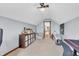 Large bonus room featuring a seating area, shelving, and access to another room at 7304 E Stop 11 Rd, Indianapolis, IN 46259