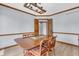 Dining room with wood floors, a traditional table, and comfortable chairs at 7304 E Stop 11 Rd, Indianapolis, IN 46259
