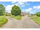 Brick home with a large yard and long driveway, accented by mature shade trees at 7304 E Stop 11 Rd, Indianapolis, IN 46259