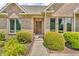 Close up on the front door of this home with a brick facade and manicured hedges at 7304 E Stop 11 Rd, Indianapolis, IN 46259