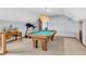 Game room features a classic wood pool table and exercise equipment at 7304 E Stop 11 Rd, Indianapolis, IN 46259