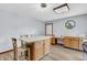 Bright eat-in kitchen area with an island that includes seating for three and light hardwood floors at 7304 E Stop 11 Rd, Indianapolis, IN 46259