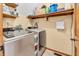 Bright laundry room featuring a modern washer and dryer and built-in storage shelves at 7304 E Stop 11 Rd, Indianapolis, IN 46259