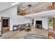 Comfortable living room with wood floors, a cozy leather sofa, and staircase at 7304 E Stop 11 Rd, Indianapolis, IN 46259